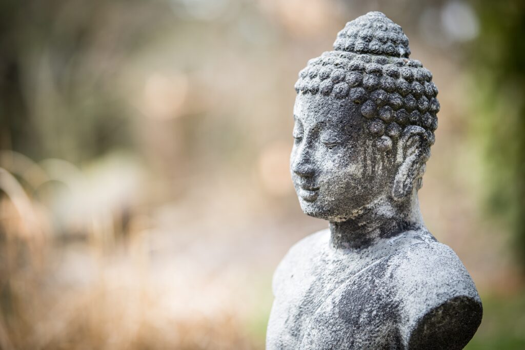 gray stone buddha in nature 