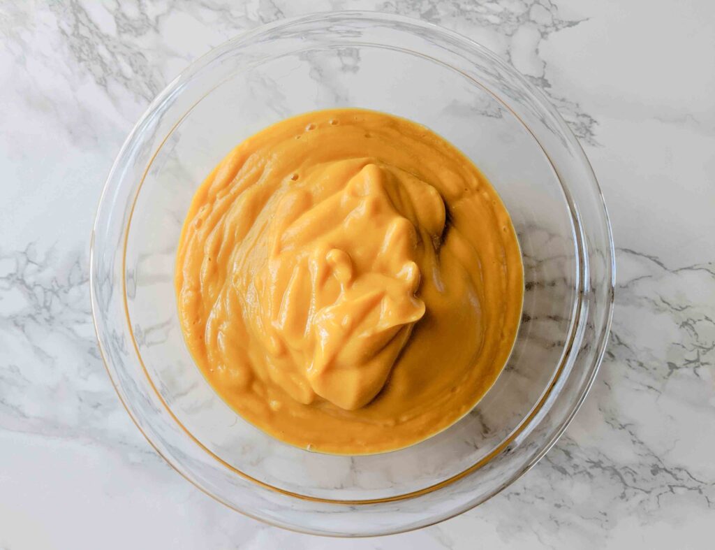 butternut squash sauce in glass bowl on white countertop