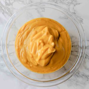 butternut squash sauce in glass bowl on white countertop