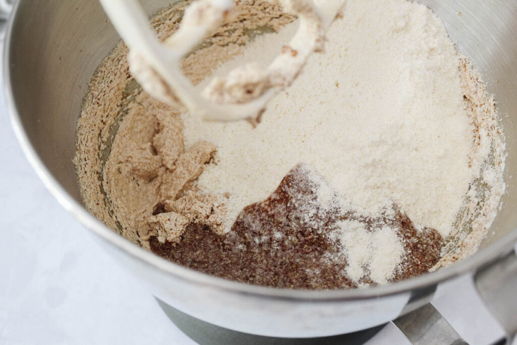 dairy free chocolate chip cookie batter being mixed with stand mixer