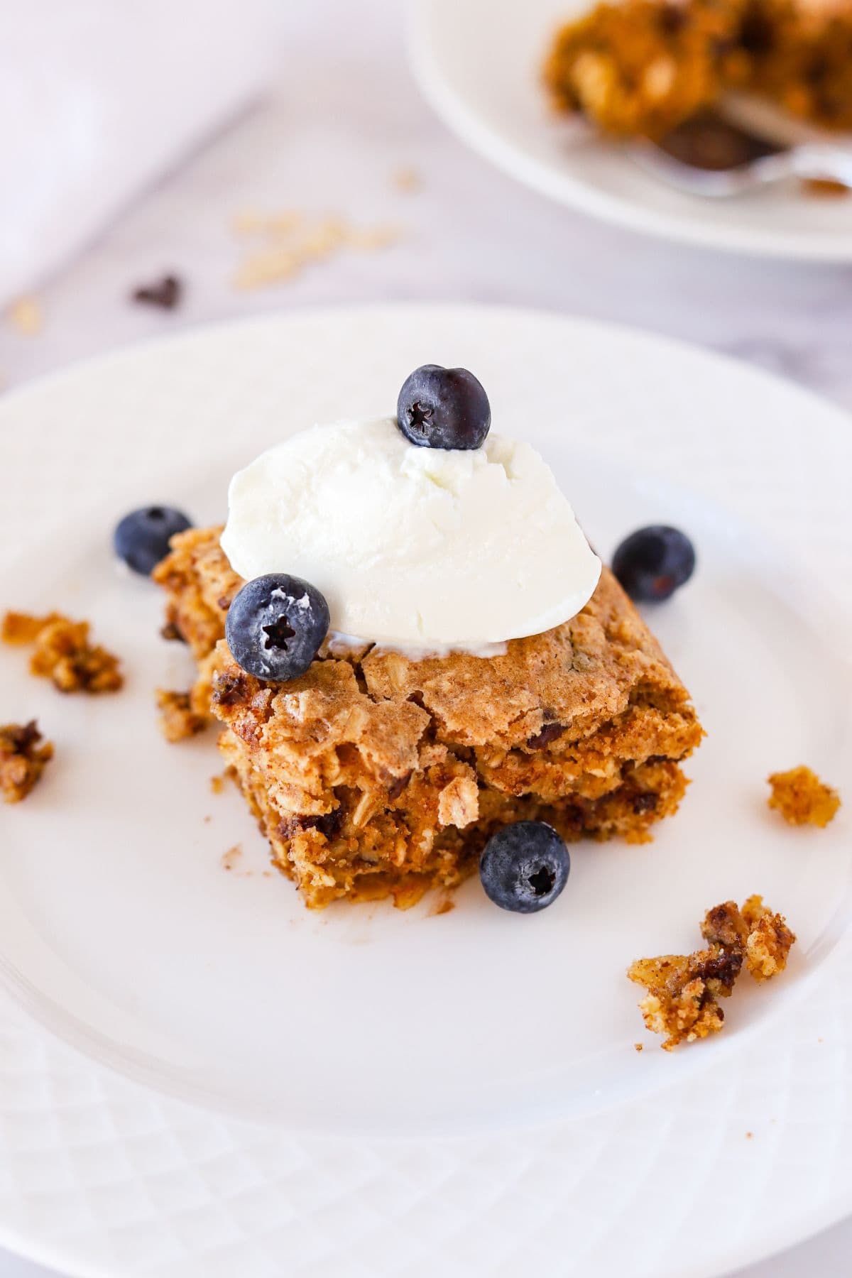 Simple baked oats without bananas on plate with toppings.