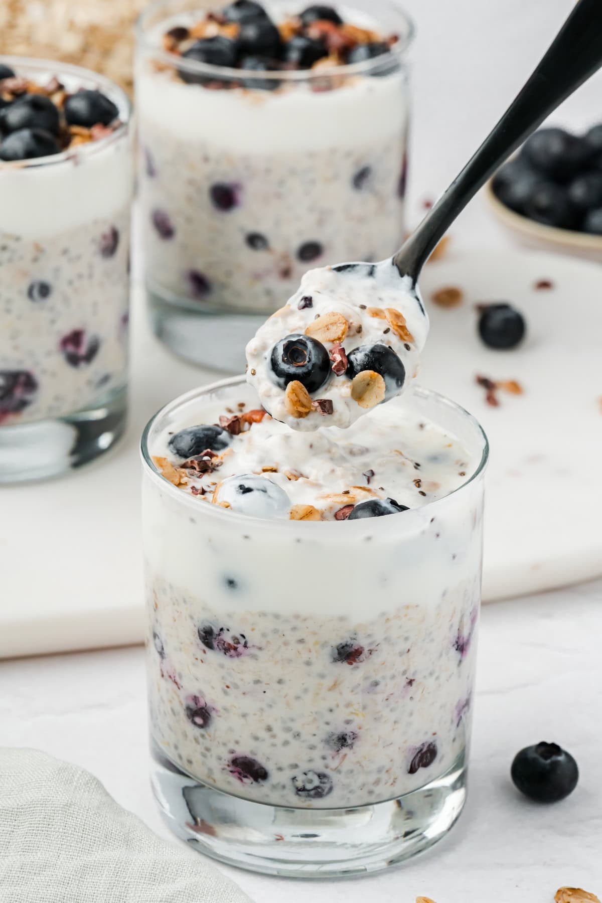 Scooping out a bite of blueberry lemon overnight oats to show texture.