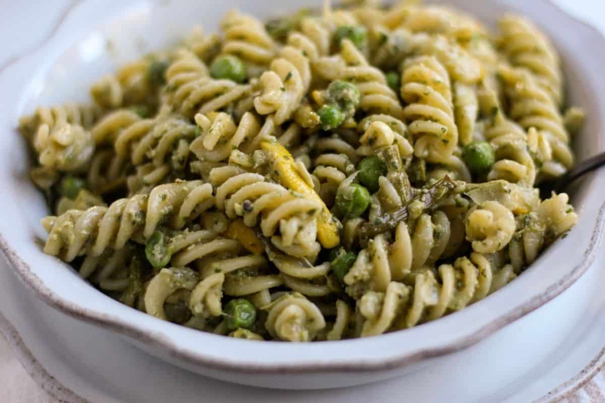 Close up of gluten free pesto pasta salad to show texture and the look of the roasted vegetables.