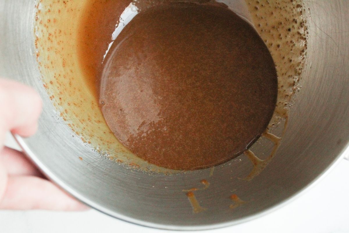 Showing the inside of a mixing bowl making gluten free sprinkle cookies with creamed avocado oil, maple syrup, vanilla extract and coconut sugar to show texture once blended.