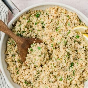 Close up of a spoon scooping lemon herb quinoa.