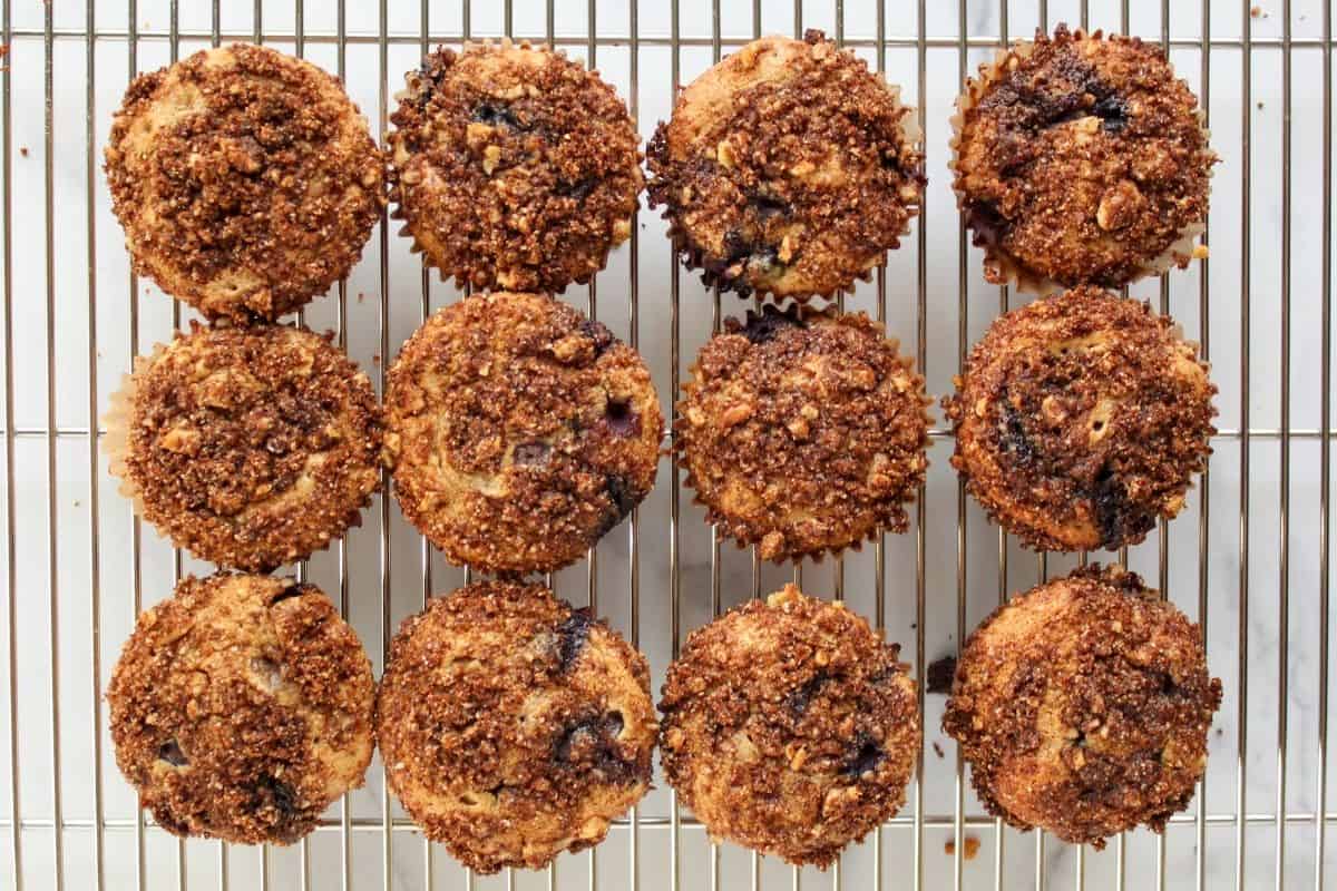 Fresh baked gluten and dairy free blueberry muffins cooling on a wire rack.